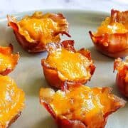 bacon wrapped tater tot cups on a plate
