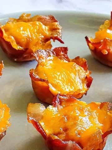 bacon wrapped tater tot cups on a plate