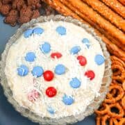 cream cheese dip topped with candy pieces and coconut flakes