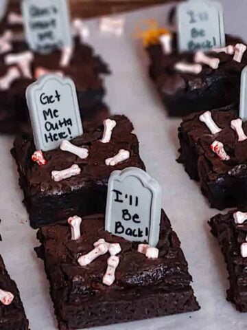 sliced halloween graveyard brownies on parchment paper