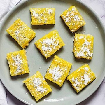 creamy lemon bars on a gray plate
