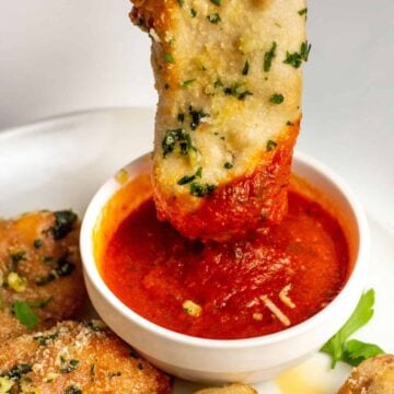 no-cook pizza sauce with a pizza stick being dipped into it