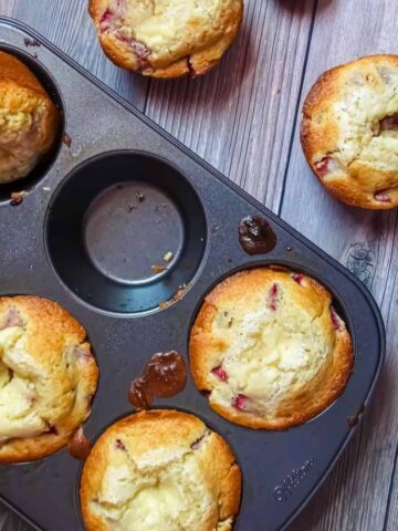 strawberry cream cheese muffins in a muffin pan