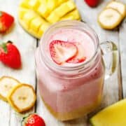 mango strawberry banana smoothie in a mason jar