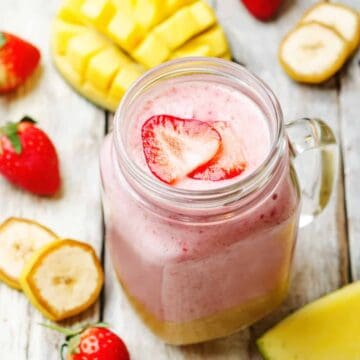 mango strawberry banana smoothie in a mason jar