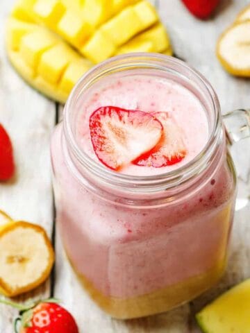 mango strawberry banana smoothie in a mason jar